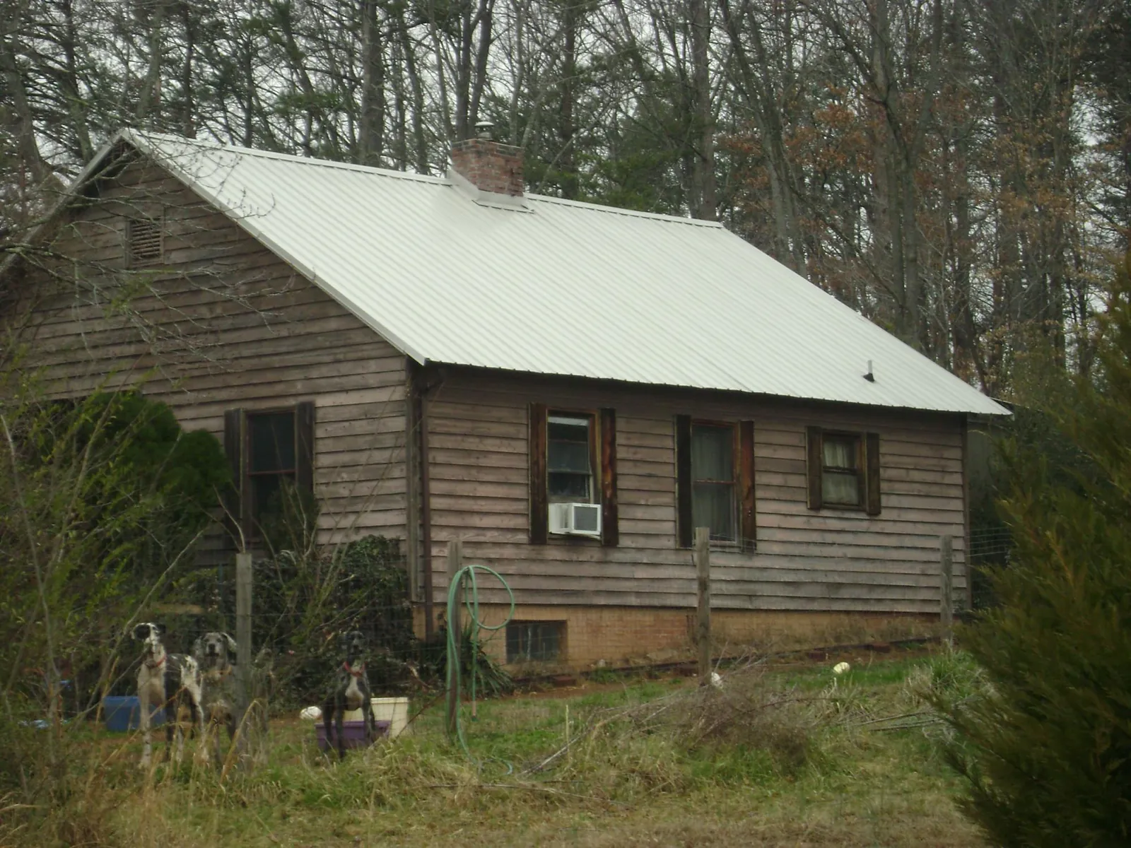 White metal roof on an old wood sided farmhouse, from a Metal Roof Installation job in Orfordville